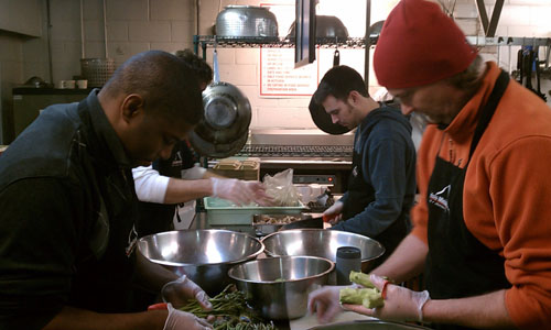 RiverDogs staff helping prepare nutritious meals to serve to guests of Crisis Ministries.