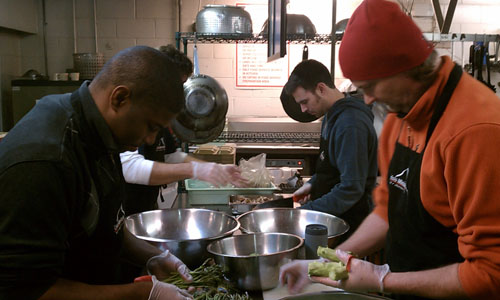 RiverDogs staff helping prepare nutritious meals to serve to guests of Crisis Ministries. 