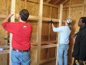The RiverDogs staff helps build a shed at Windwood Farm Home for Children.