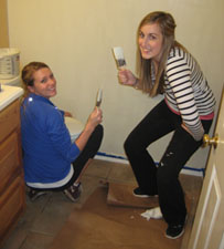 Special Events Manager, Kristen Wolfe and Promotions Intern, Haley Kirchner paint during their time volunteering at Windwood Farm Home for Children. 