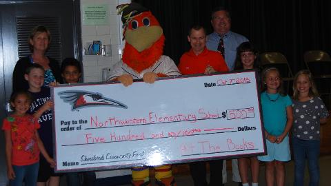 Sherman presents a $500 check to Northwestern Elementary