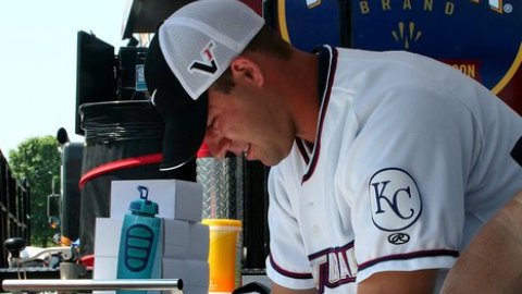 Naturals' catcher Ryan Eigsti helps serve up a meal in Jolin on Monday, June 6th. (Fran Johnson)