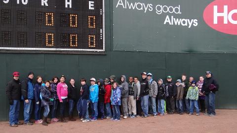 Students that completed Slugger's Reading Challenge pose for a picture in front of the Maine Monster on April 7th.