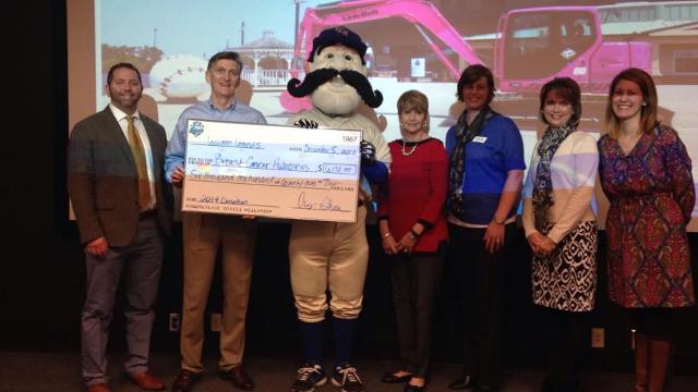 Lexington Legends President/COO Andy Shea (at left) and LBX President/CEO Eric Sauvage (second from left) present a check to representatives of Kentucky Cancer Link, Susan G. Komen and the Markey Cancer Center for funds raised in the Legends' annual Breast Cancer Awareness game. The Legends make donations to a variety of organizations throughout the region. (Lexington Legends)