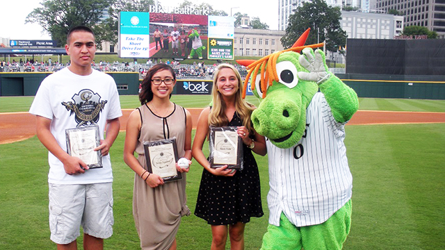 From L-R -- 2014 Charlotte Knights Healthcare Scholarship recipients: Adam Miranda (NC State), Xena Nguyen (UNC - Chapel Hill), Sarah York (Wake Forest) and Homer the Dragon.