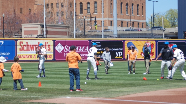 Ducks play catch with kids on field prior to MS awareness day at Canal Park.